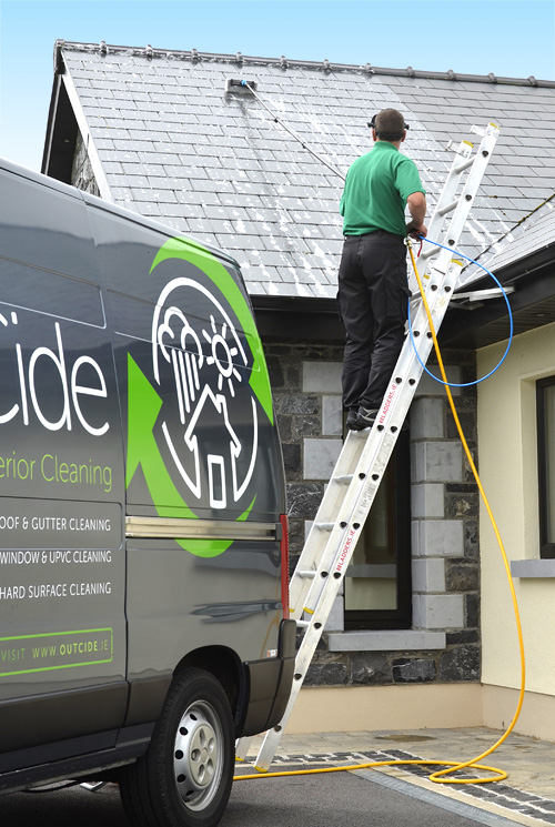 Roof cleaning with OutCide's pole and brush system.